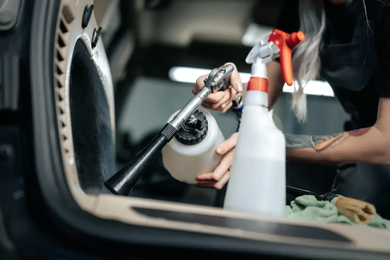 woman cleaning car salon with polishing spray in c 2023 11 27 04 53 41 utc